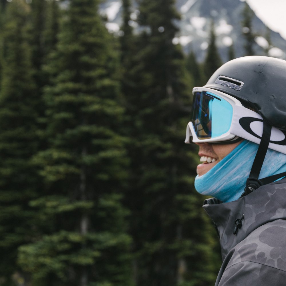 A man wearing the Buff Thermonet® "Protect Our Winters" Neckwear in Protector Blue