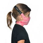 Side profile image of a kid wearing a Buff Filter Kids' Mask in Nympha Pink